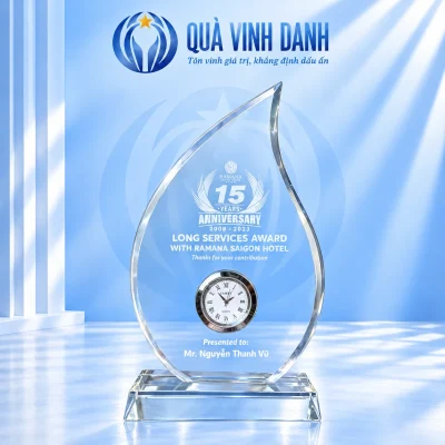 Biểu trưng pha lê ngọn lửa mẫu 20 có đồng hồ tròn và đế trong suốt trên nền xanh