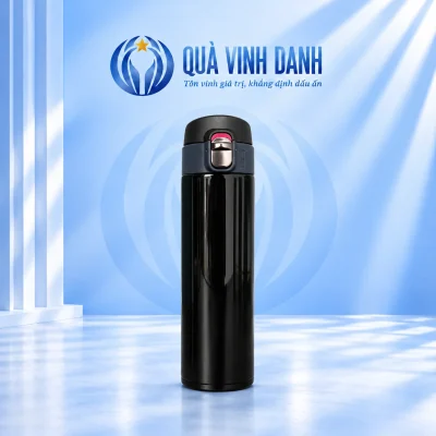 Bình giữ nhiệt nắp bật thân đen bóng chốt sáng trên nền Quà Vinh Danh không bục