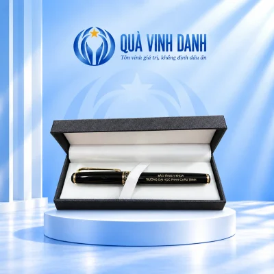 Bút đen BKV 007 vòng tổ ong màu vàng trong hộp lót trắng, giữ hai dòng tên đơn vị nguồn trên nền Quà Vinh Danh