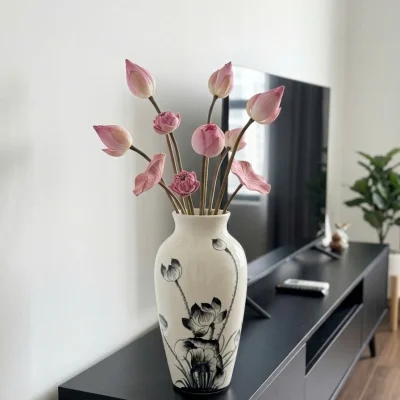 Bối cảnh minh họa từ nguồn: lọ men trắng sen đen cắm sen hồng đặt cạnh kệ trong phòng
